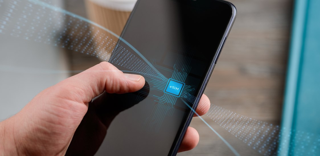 Phone with eSIM technology concept. Hand holding the mobile device